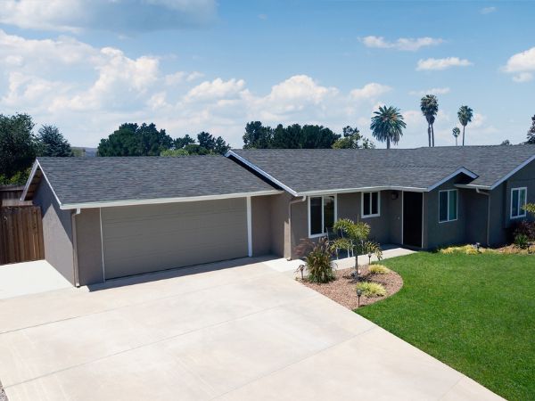 House with Malarkey Black Oak asphalt shingle roof in deep black with oak-brown accents