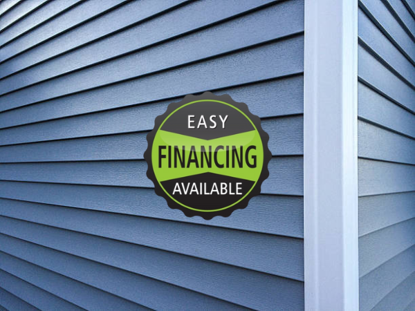 Close-up of blue vinyl siding installed by Fisher Construction with easy financing available for siding replacement and exterior upgrades.