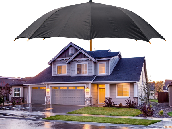 Home protected by durable siding represented by a large umbrella, highlighting how quality siding shields your home from weather and moisture damage.