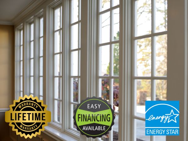 Large windows with white frames in a room, showcasing 'Lifetime Warranty,' 'Easy Financing Available,' and 'Energy Star' badges, with a scenic outdoor view.