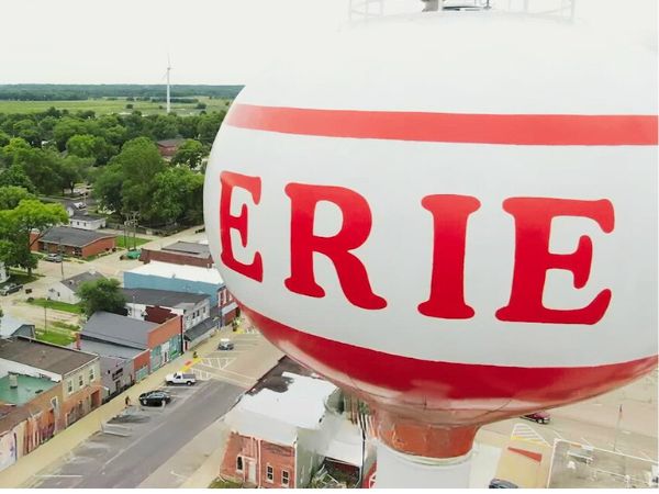 Erie water tower with town name and small-town street view for roofing services