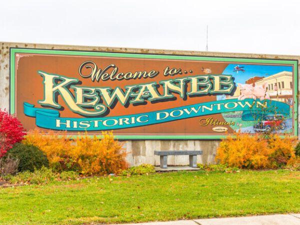 Welcome to Kewanee Historic Downtown mural with autumn foliage for roofing services